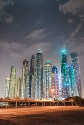 Cloudy sky over illuminated metropolis
