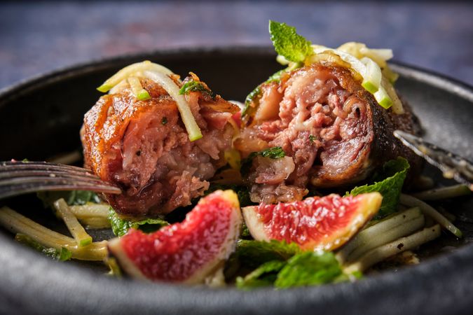 Delicious dish with pig trotter and vegetables on plate