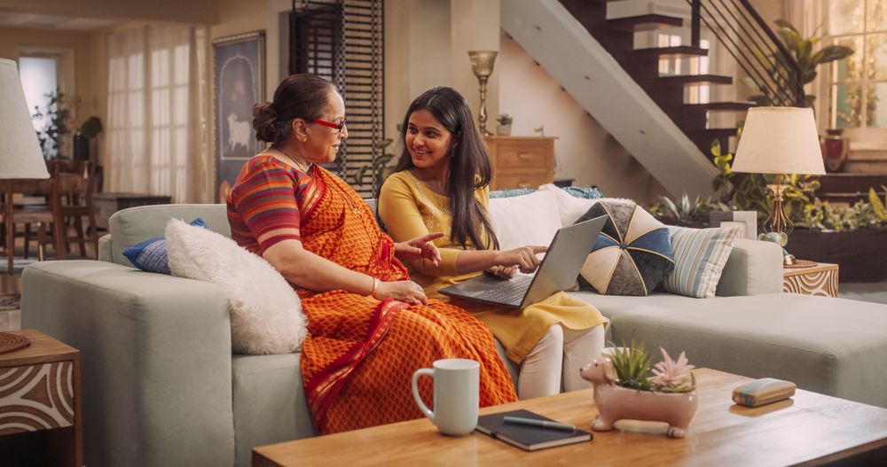 Excited Indian Mother and Daughter Bonding Over Deals and Clothing Sales.