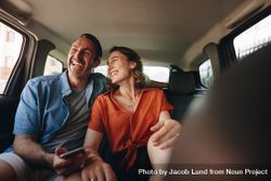 Loving couple travelling in the backseat of a cab 41Wk70
