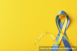 Ribbon in Ukrainian flag colors on yellow background with copy space 56p8jb