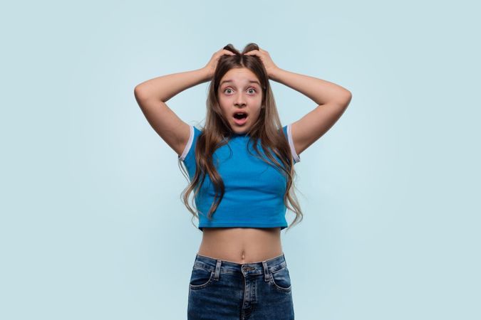 Girl holding head in surprise or shock