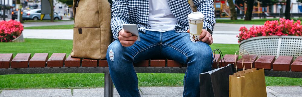 Man with mobile looking camera