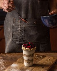 Chef adding berries to granola parfait