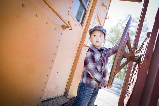 Boy Having Fun on Railroad Car