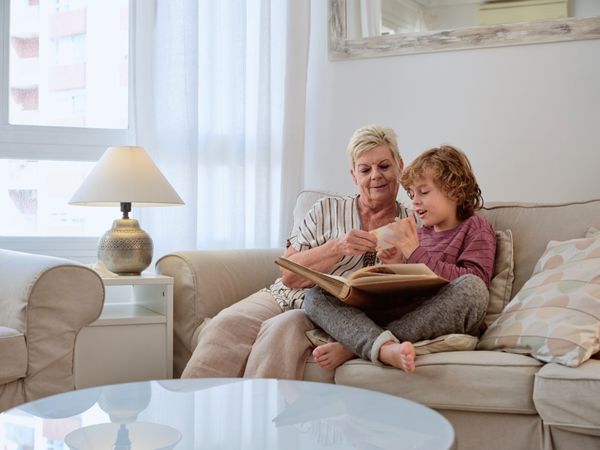 Grandmother and grandson discussing photo from album at home
