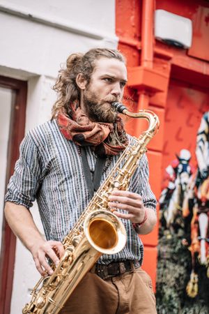 Male saxophonist plays Sax in the street