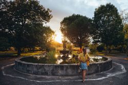 Female admiring sunset in park