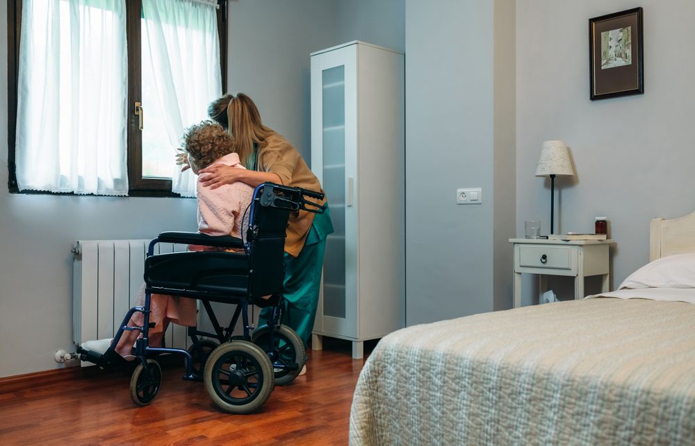 Caregiver showing the view through the window to mature patient