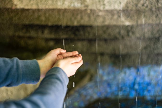 Kid hands under the water flow