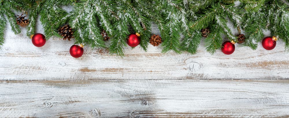 Christmas branches and ornaments on rustic wooden background