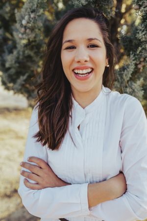 Confident young woman standing in park