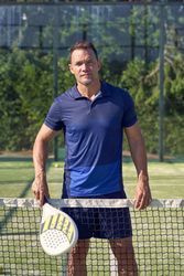 Man with racket on playground