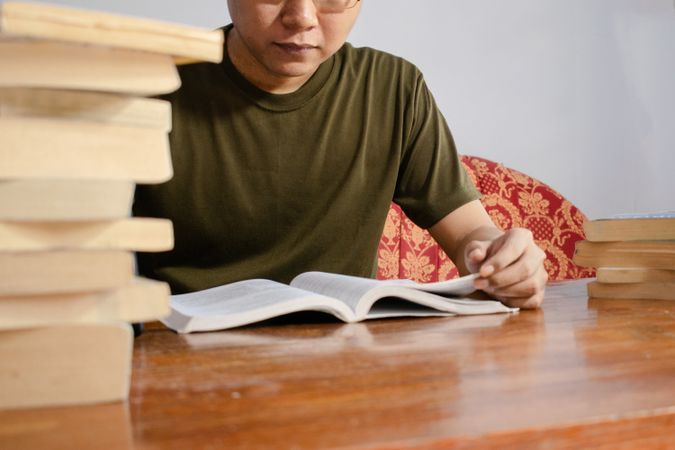 Asian young student study, reading and writing sit on sofa at living room
