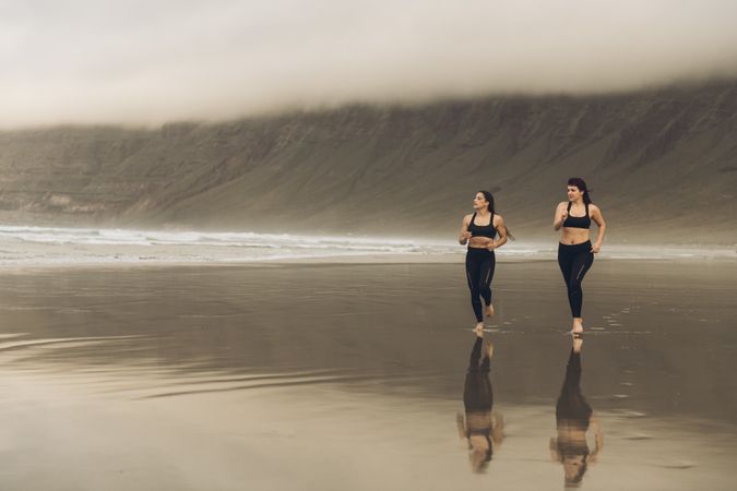 Anonymous women running near sea