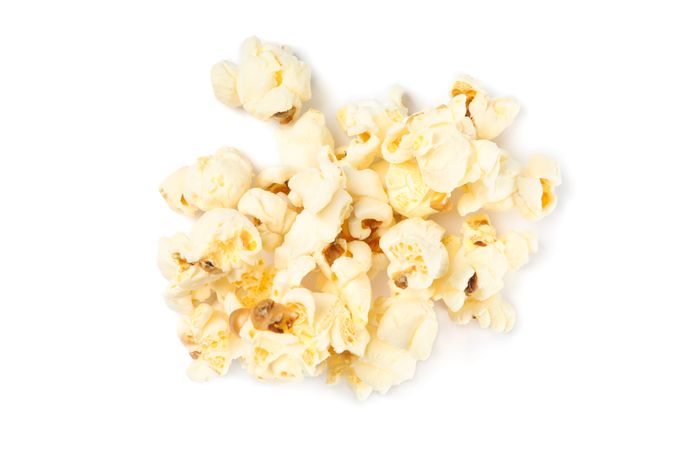 Popcorn pile isolated on blank background, close up