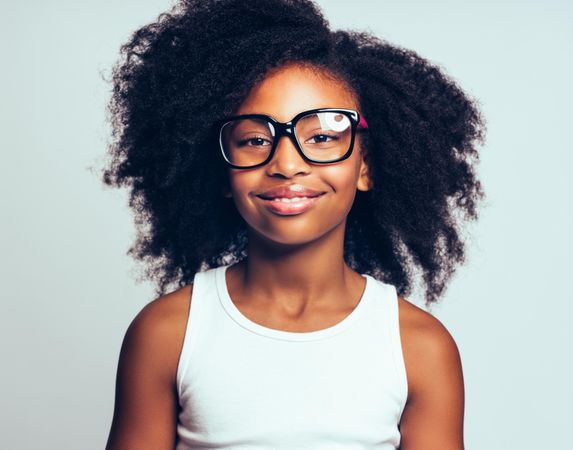 Portrait of confident smiling girl wearing large glasses
