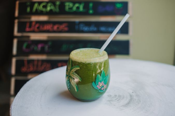 Delicious green smoothie with frothy in glass
