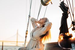 Older woman with her hair back on a sailboat