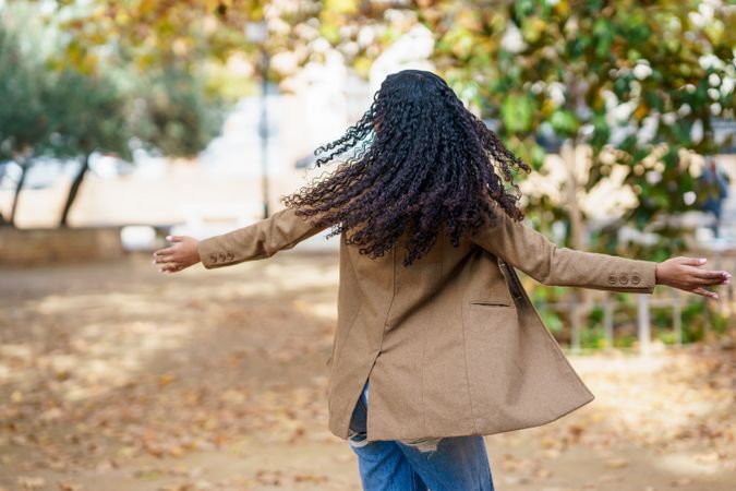 A Joyful Woman Twirling in the Beautiful Outdoors Surrounded by Natures Splendor