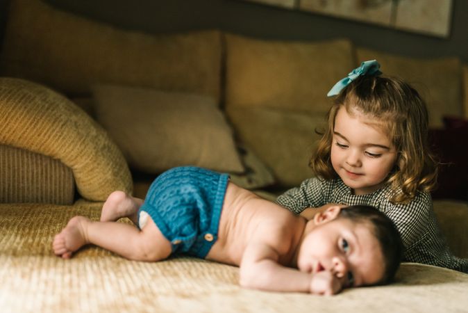 Little girl caring baby