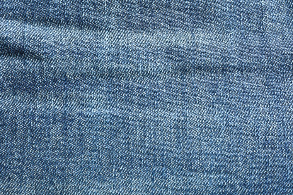 Texture of blue jeans as background, space for text