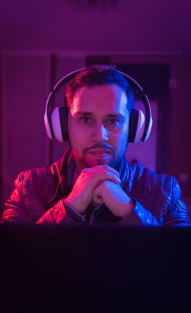 Man listening cheerfully to music with headphones.