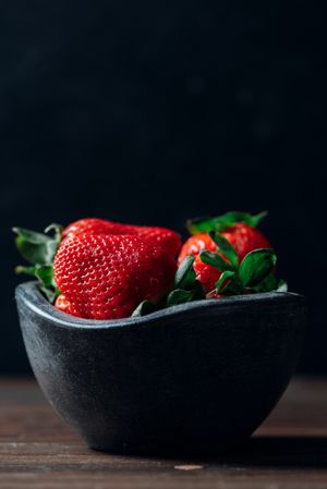 Fresh ripe strawberries in concrete bowl