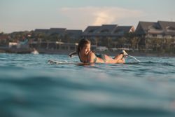 woman on surf board floating on water