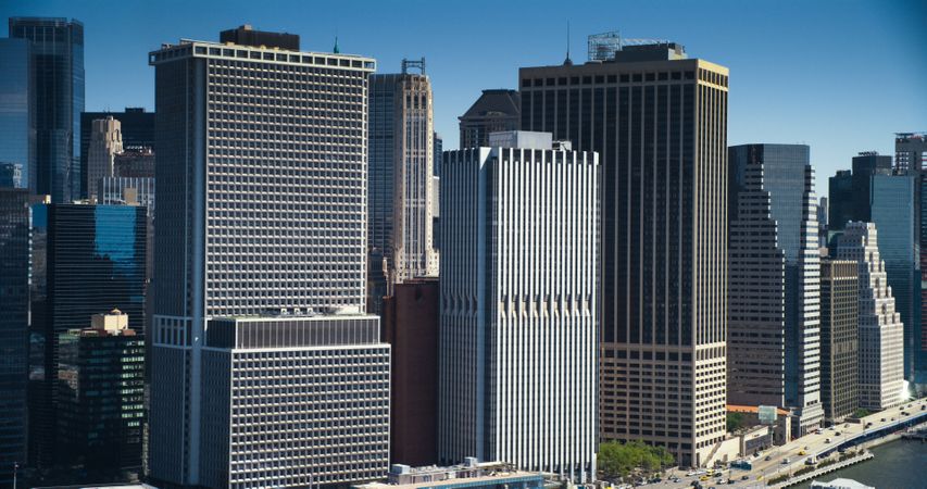 Wall Street Financial District Architecture in New York City, USA. Aerial Photo with Office Buildings and Skyscrapers on a Summer Sunny Day with Blue Sky