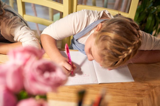 Preteen schoolgirl focusing on task during lesson