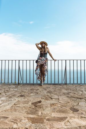 Stylish woman on terrace of seashore