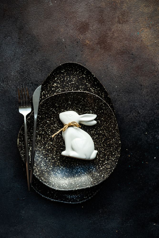 Easter table setting with ornamental rabbit on plate
