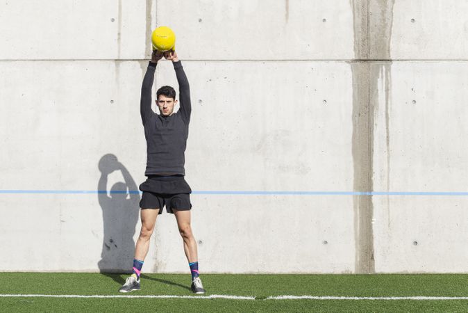 Man training with ball near wall