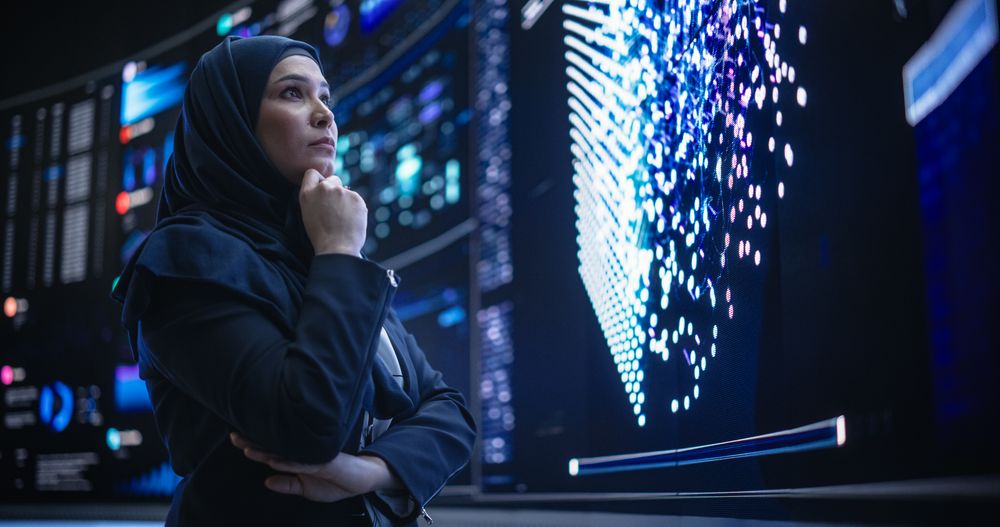 Portrait of a Smart Focused Middle Eastern Software Engineer Analyzing Neural Network Big Data on a Digital Screen.
