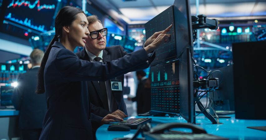 Diverse Female and Male Traders Analyzing Real-Time Financial Data and Reports About the State of the Finance Market.