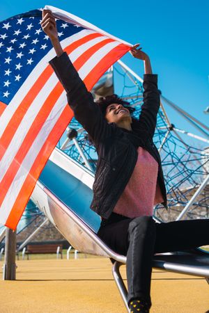 Black woman with afro hair and an american flag.