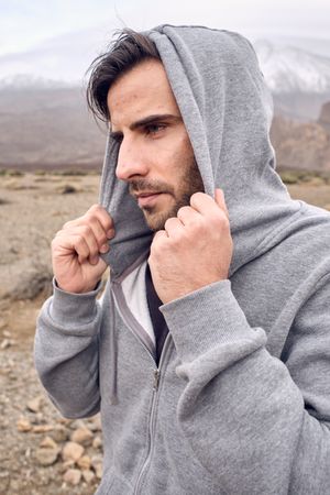 man in hoodie in mountains