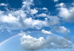 Full rainbow in blue sky