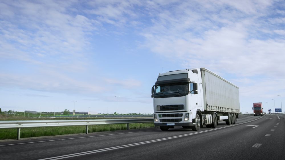 Speeding Semi Truck with Cargo Trailer Drives on the Highway.