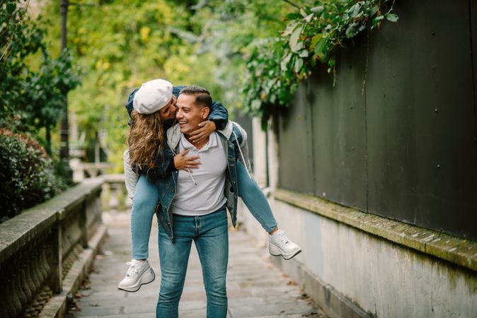 Happy couple having fun together at overgrown city street