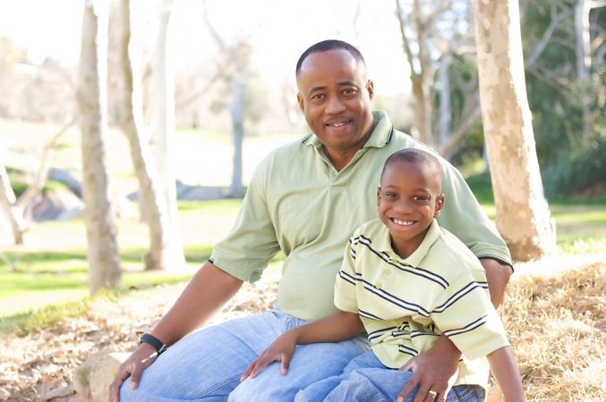 Black Man and Child Having Fun At Park