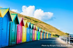 Colorful cabins near hill under blue sky 4Aox80