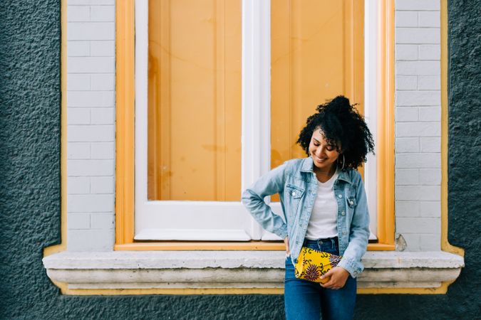 Smiling female by yellow window