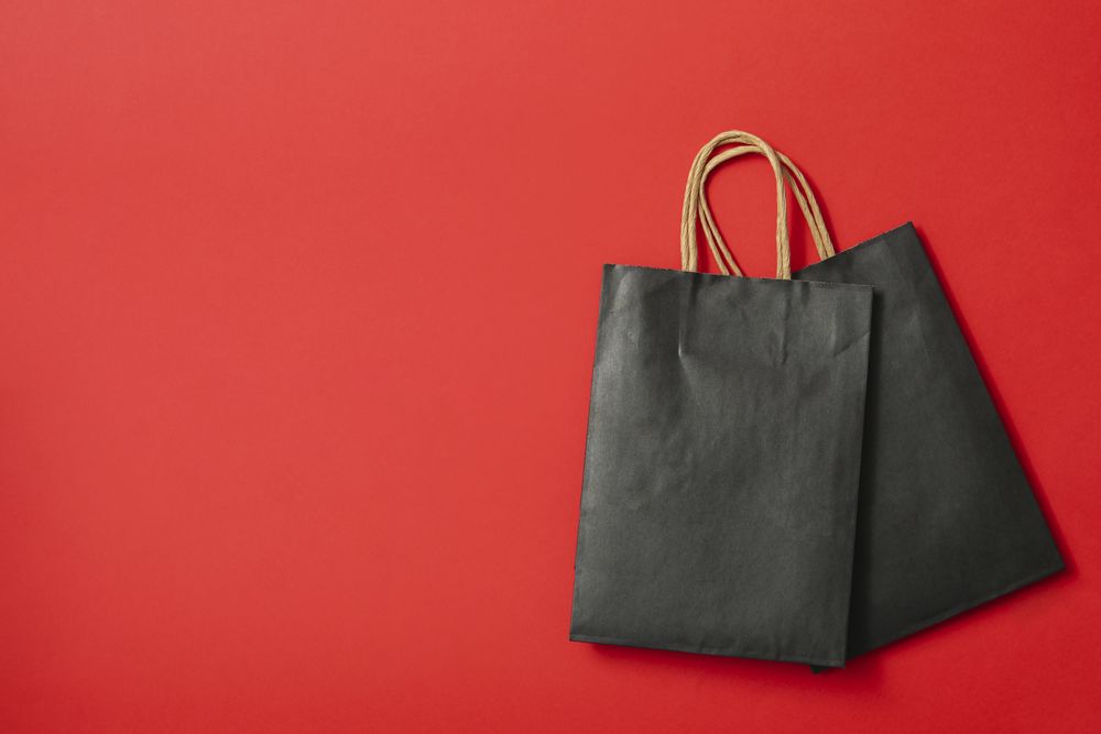 paper bags on red background, space for text