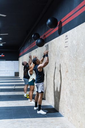 Hispanic sportspeople training with medical balls