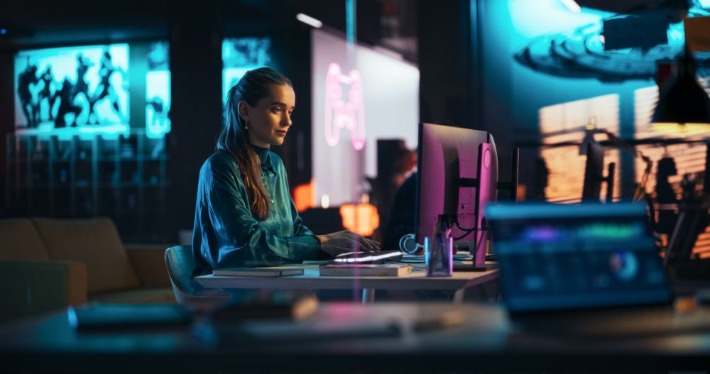 Portrait of a Beautiful Happy Female Using Desktop Computer, Analysing Data, Thinking and Solving Problems.