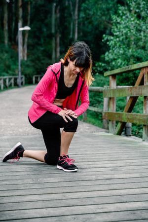 Athlete woman crouched with knee injury