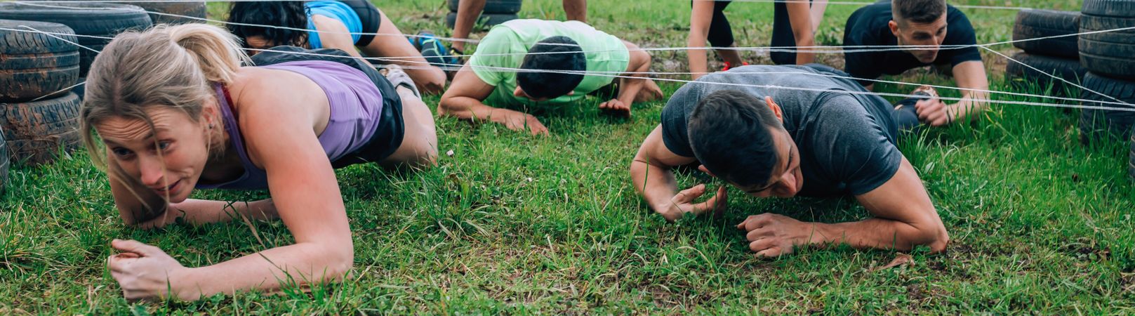 Participants in an obstacle course crawling