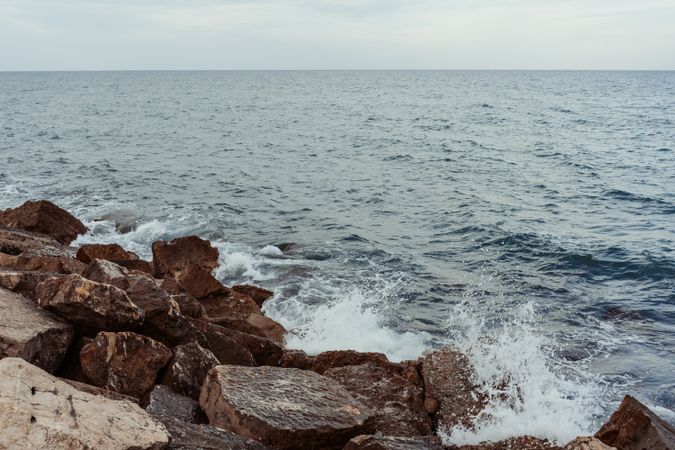 Sea waves hitting rocky cliff